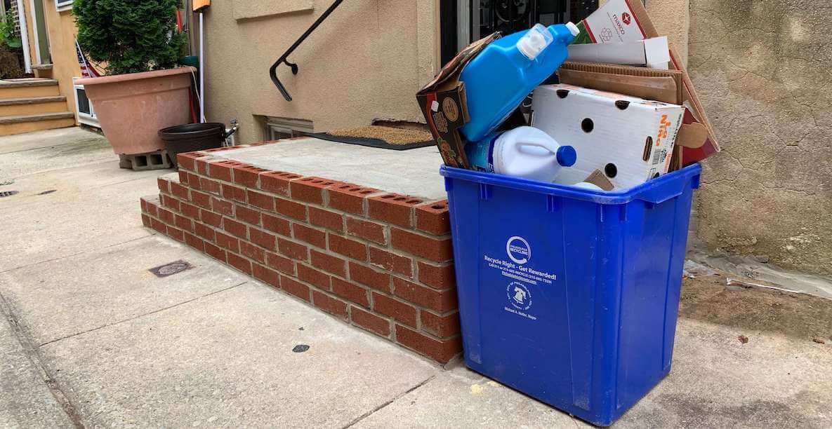 Full recycling bin outside a Philadelphia rowhome