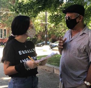 Gabriela Rivera talking with a community member at a “Cafe and Empanadas” event in August 2020