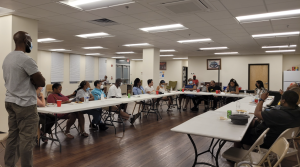Derrick leads a community talk in Mantua
