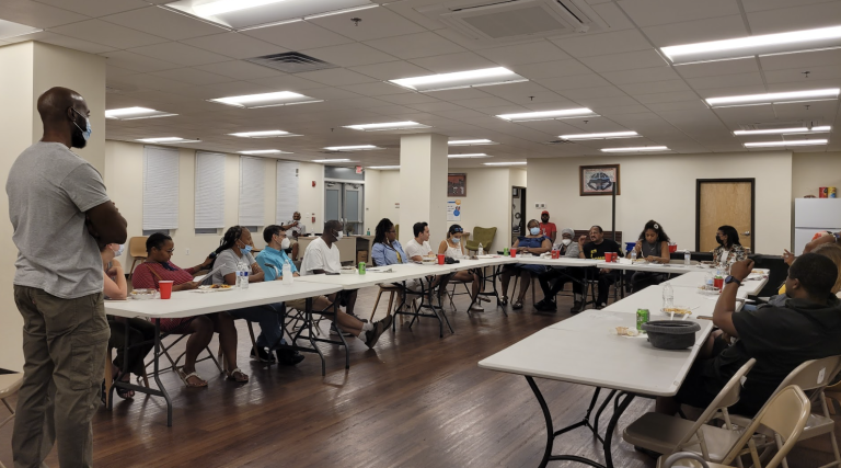 Derrick leads a community talk in Mantua