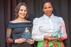Cassie and Jean smile and pose after receiving their Nonprofit Women of Merit award from Al Dia News.