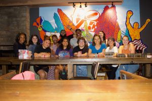 Some of the Resolve Philly staff posed in front of an indoor mural